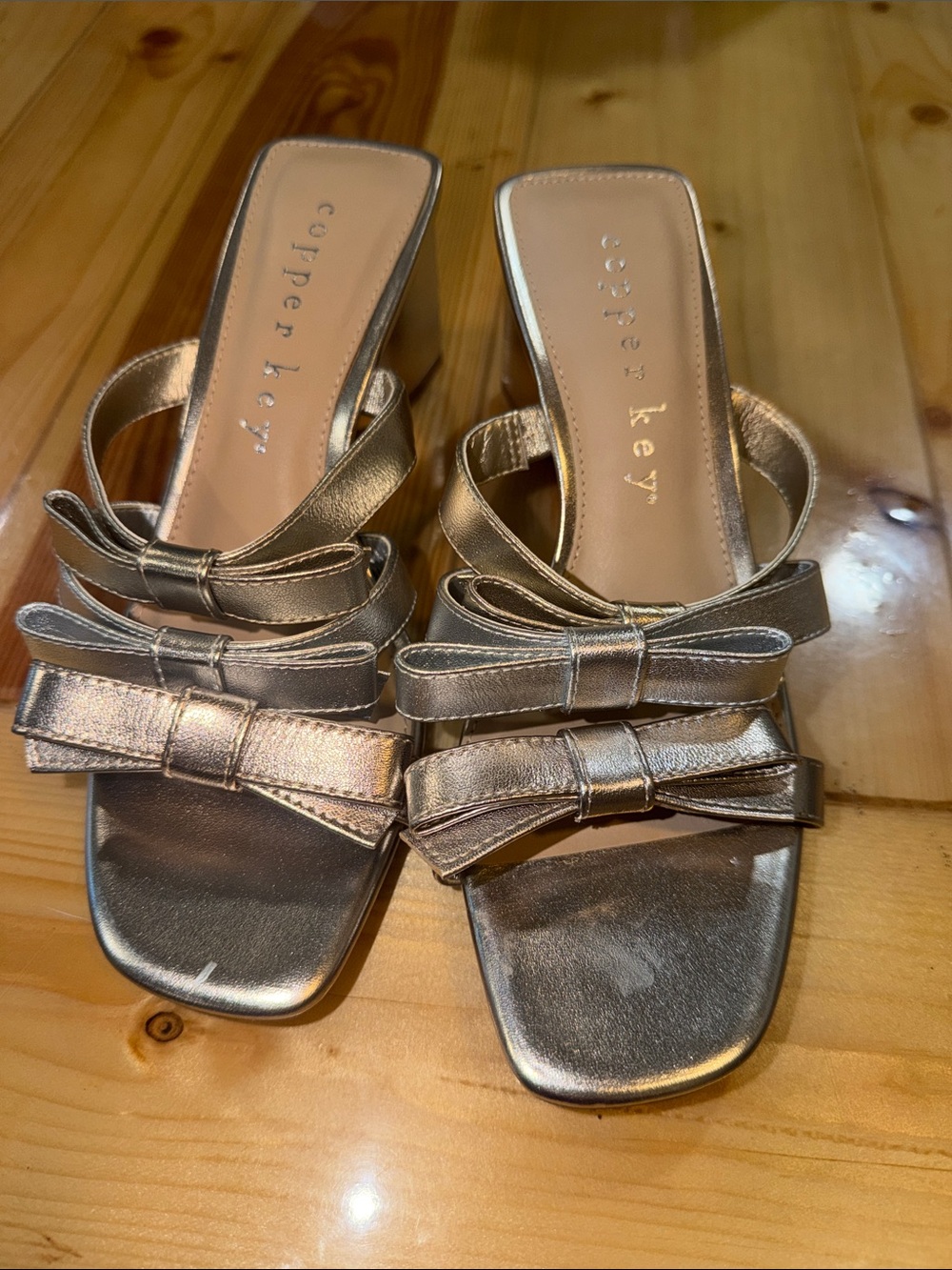 Copper Key Metallic Bow Slip-On Mules in Silver